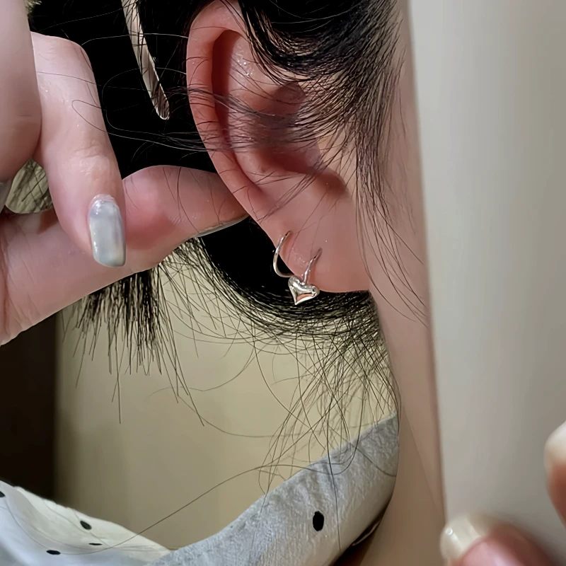 Model showcasing the dangle and style of the 14K Gold-Plated Heart Threader Earrings