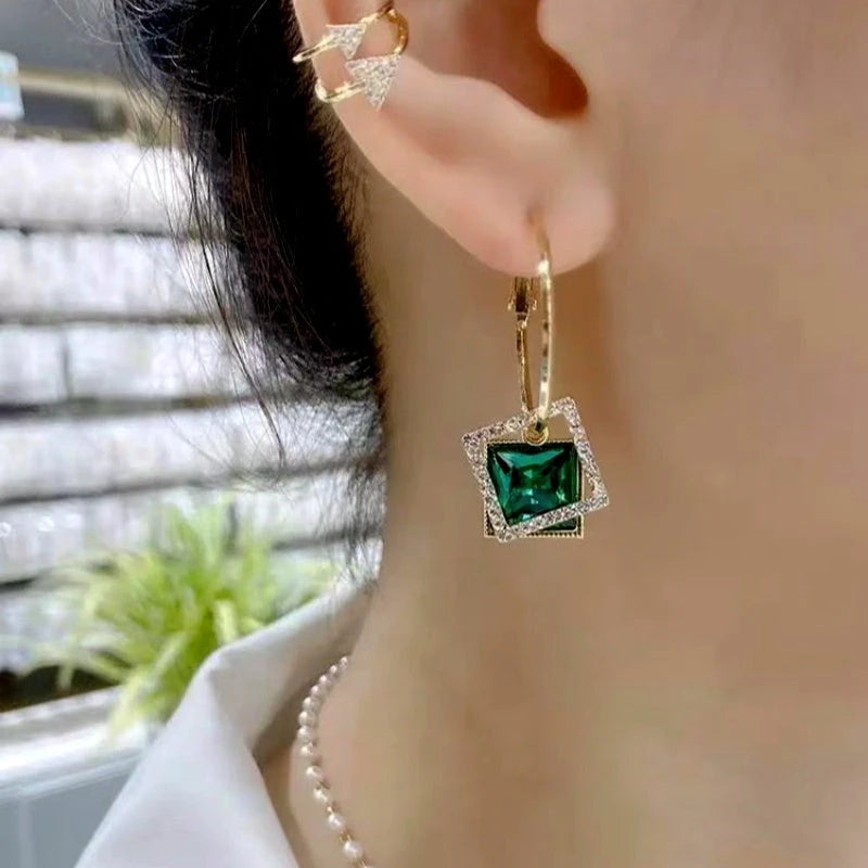 Model showcasing the dangle and style of the 14K Gold-Plated Hollow Crystal Earrings