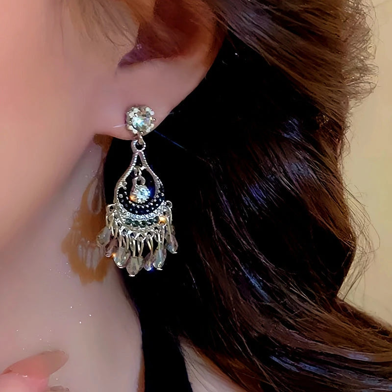 Model showcasing the dangle and style of the 14K Gold-Plated Hollow Crystal Tassel Earrings