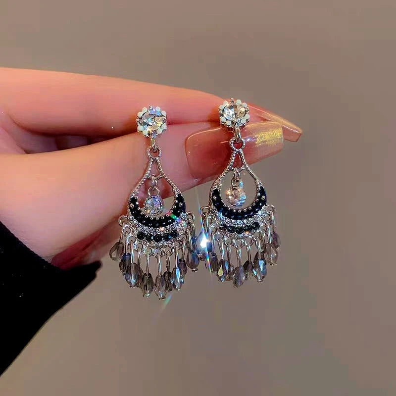 Angled view of the 14K Gold-Plated Hollow Crystal Tassel Earrings