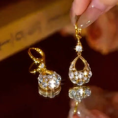 Angled view of the 14K Gold-Plated Hollow Diamond Water Drop Earrings