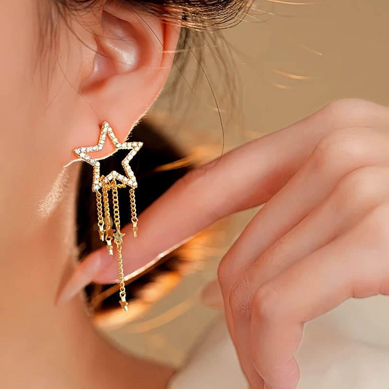 Angled view of the 14K Gold-Plated Hollow Five-Pointed Star Tassel Earrings