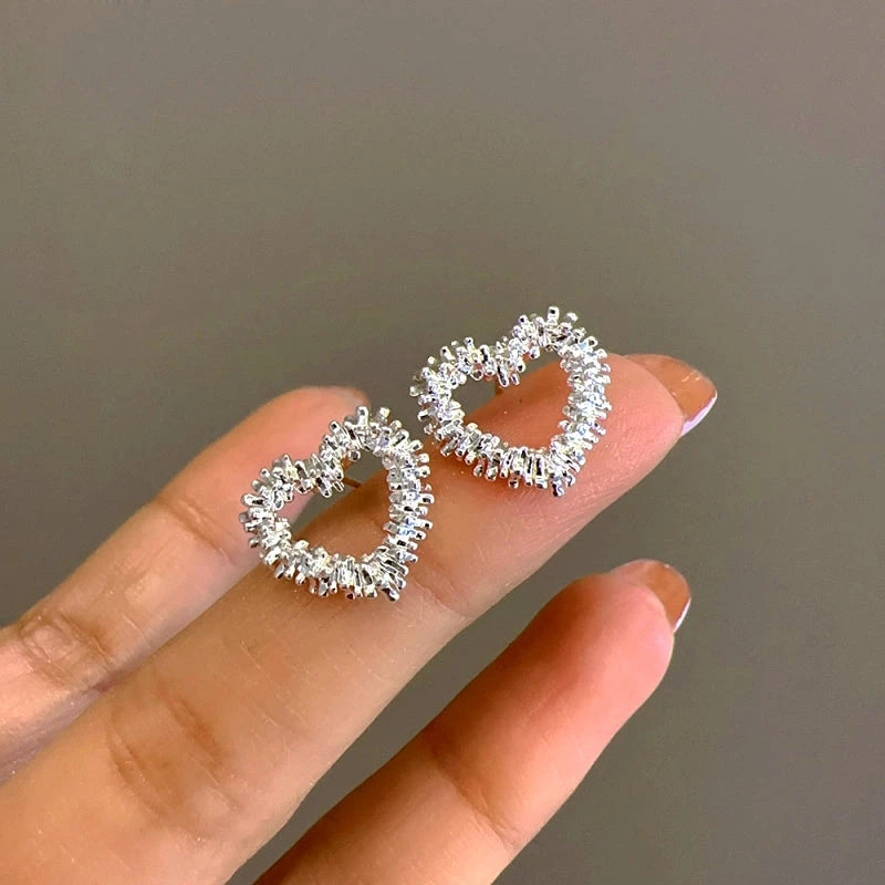 Angled view of the 14K Gold-Plated Hollow Heart Stud Earrings