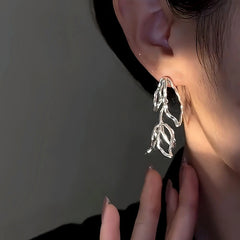 Close-up detail of the sparkling zircons and plating on the Hollow Tulip Earrings