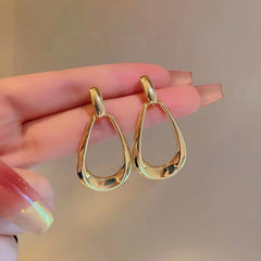 Angled view of the 14K Gold-Plated Hollow Water Drop Earrings