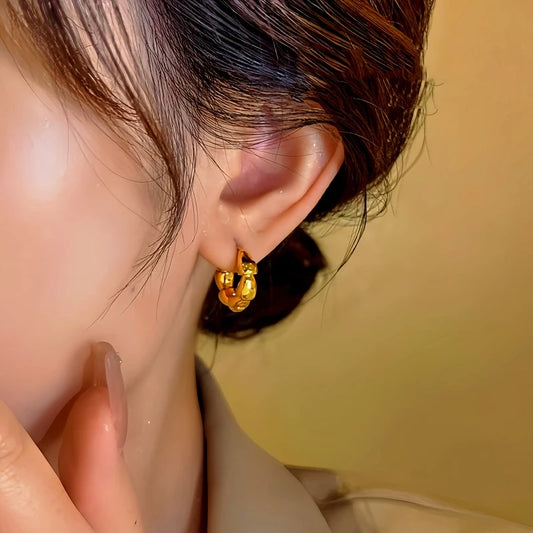 Model showcasing the dangle and style of the 14K Gold-Plated Hoop Earrings