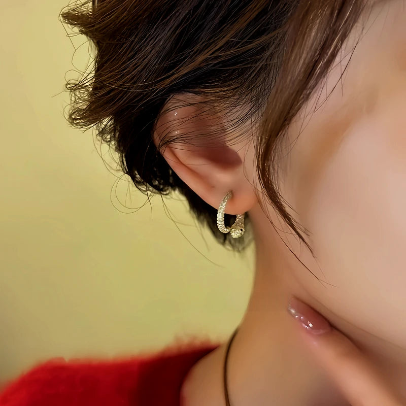 Close-up detail of the sparkling zircons and plating on the Ouroboros Earrings