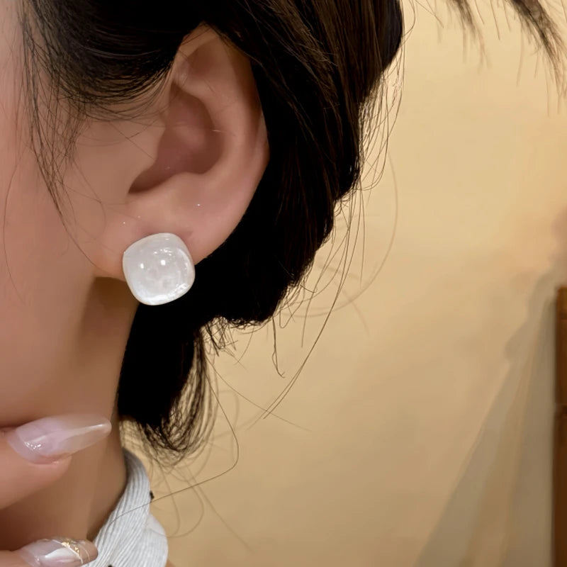 Model showcasing the dangle and style of the 14K Gold-Plated Jade Sugar Cube Stud Earrings