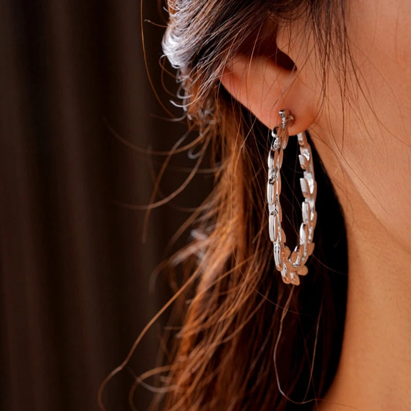 Angled view of the 14K Gold-Plated Leaf C-Shaped Hoop Earrings