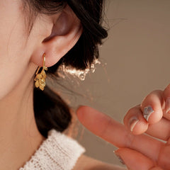 Close-up detail of the sparkling zircons and plating on the Leaf Ear Hooks