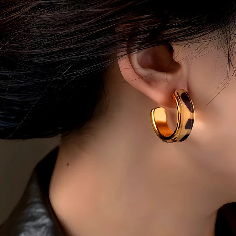 Angled view of the 14K Gold-Plated Leopard Print C-Shaped Earrings