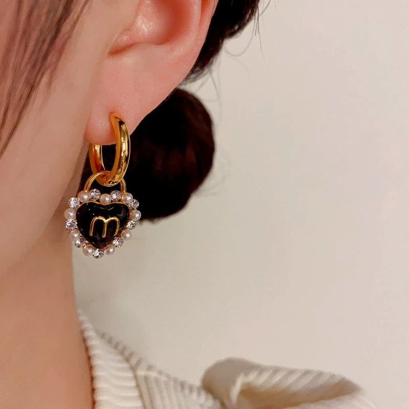 Close-up detail of the sparkling zircons and plating on the Mismatched Heart Earrings