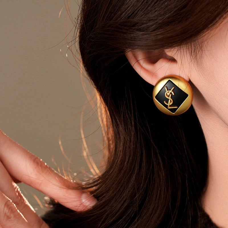 Model showcasing the dangle and style of the 14K Gold-Plated Letter Stud Earrings
