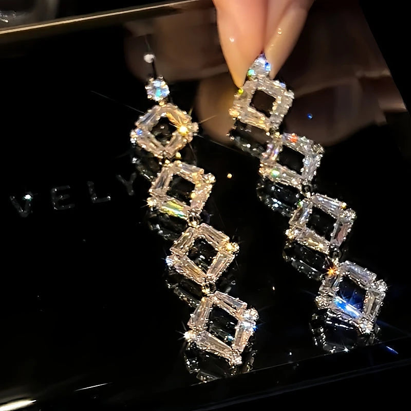 Angled view of the 14K Gold-Plated Long Crystal Tassel Earrings