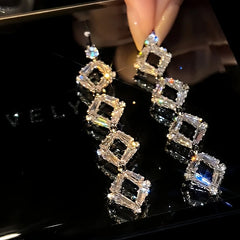 Angled view of the 14K Gold-Plated Long Crystal Tassel Earrings