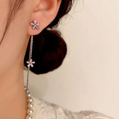 Model showcasing the dangle and style of the 14K Gold-Plated Long Diamond Flower Tassel Earrings