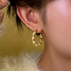 Close-up detail of the sparkling zircons and plating on the LOVE Hoop Earrings