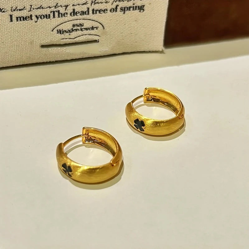 Angled view of the 14K Gold-Plated Lucky Clover Hoop Earrings