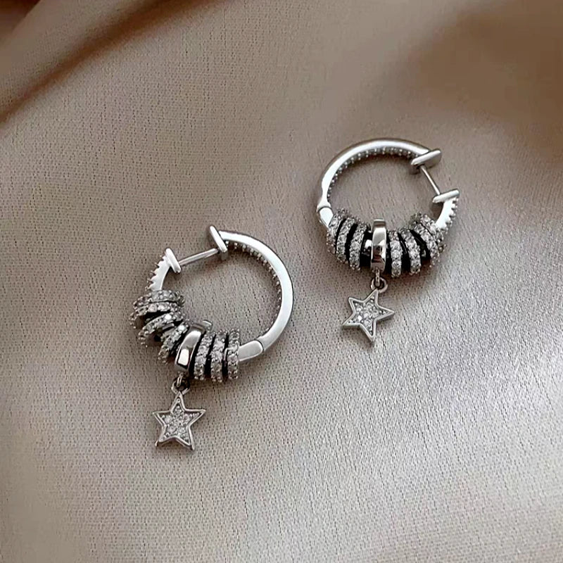 Model showcasing the dangle and style of the 14K Gold-Plated Lucky Star Zircon Earrings