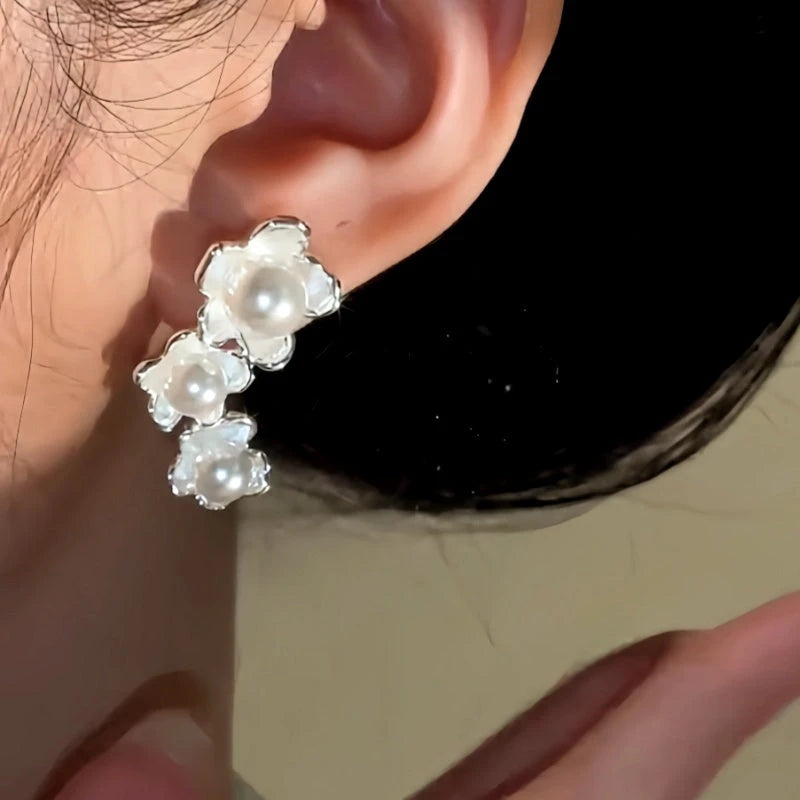 Model showcasing the dangle and style of the 14K Gold-Plated Luxury Asymmetrical Pearl Flower Earrings