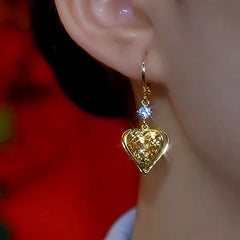 Angled view of the 14K Gold-Plated Luxury Bling Heart Earrings