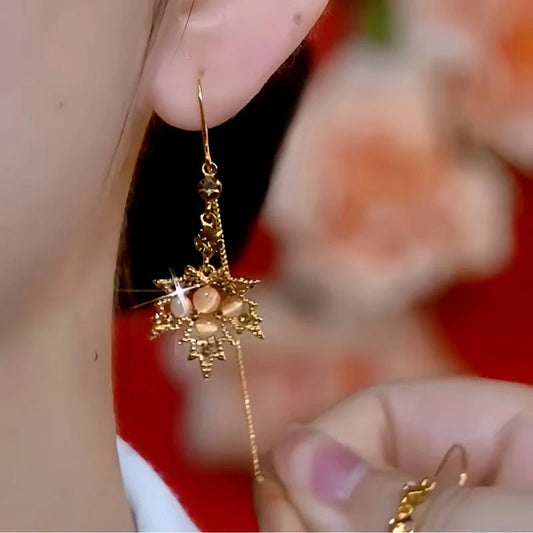 Model showcasing the dangle and style of the 14K Gold-Plated Luxury Brown Diamond Maple Leaf Tassel Threader Earrings