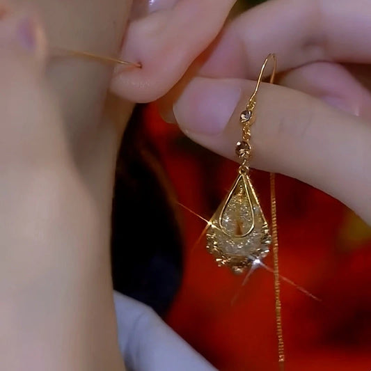 Model showcasing the dangle and style of the 14K Gold-Plated Luxury Brown Diamond Mesh Water Drop Threader Earrings