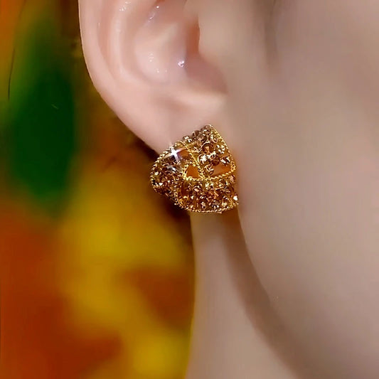 Model showcasing the dangle and style of the 14K Gold-Plated Luxury Brown Diamond Triangle Stud Earrings