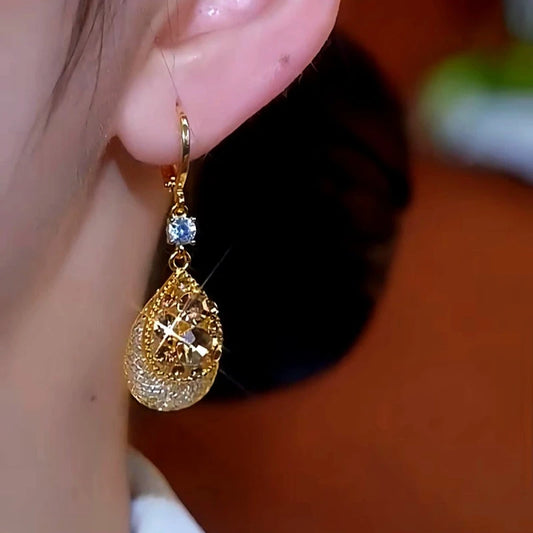 Model showcasing the dangle and style of the 14K Gold-Plated Luxury Brown Diamond Water Drop Earrings