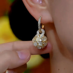 Angled view of the 14K Gold-Plated Luxury Cat's Eye Ball Earrings
