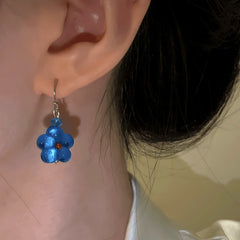 Model showcasing the dangle and style of the 14K Gold-Plated Luxury Cat's Eye Stone Blue Star Ear Hook Earrings