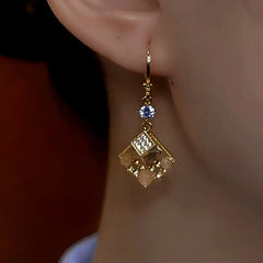 Model showcasing the dangle and style of the 14K Gold-Plated Luxury Cat's Eye Stone Geometric Square Earrings