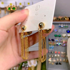 Angled view of the 14K Gold-Plated Luxury Chain Tassel Earrings