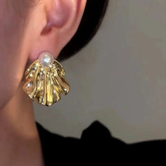Model showcasing the dangle and style of the 14K Gold-Plated Luxury Cold Style Pearl Earrings