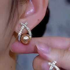 Model showcasing the dangle and style of the 14K Gold-Plated Luxury Daimond Pearl Earrings