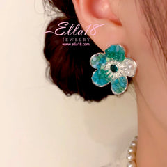 Model showcasing the dangle and style of the 14K Gold-Plated Luxury Design Beaded Petal Flower Earrings