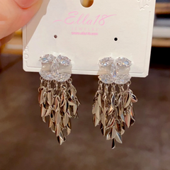 Model showcasing the dangle and style of the 14K Gold-Plated Luxury Design Leaf Tassel Earrings