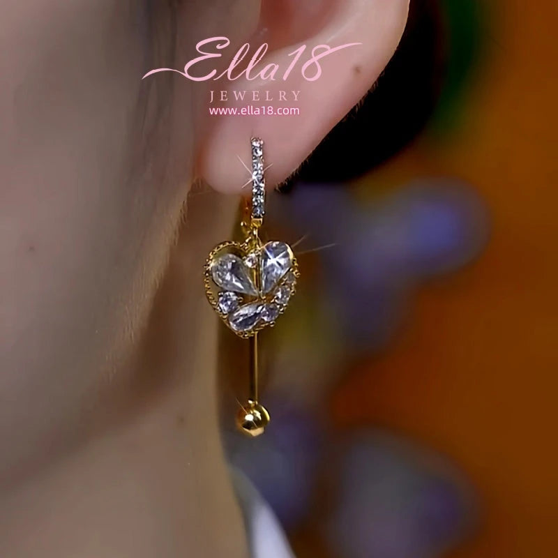 Model showcasing the dangle and style of the 14K Gold-Plated Luxury Design Zircon Diamond Heart Tassel Earrings