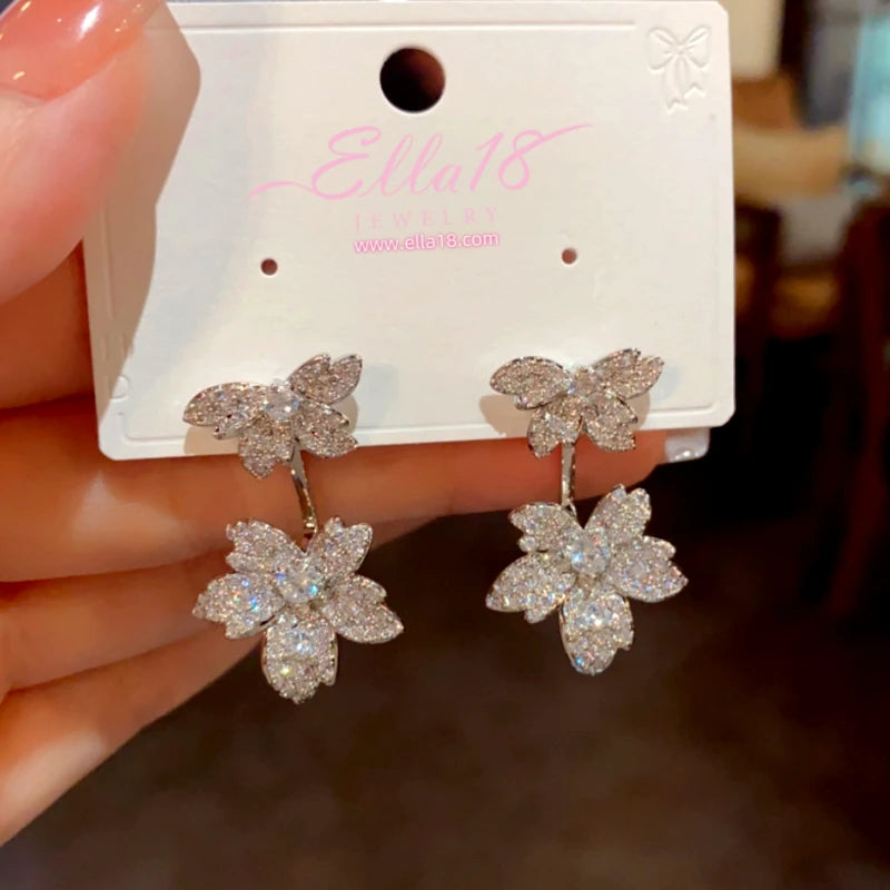 Model showcasing the dangle and style of the 14K Gold-Plated Luxury Design Zircon Diamond Maple Leaf Earrings