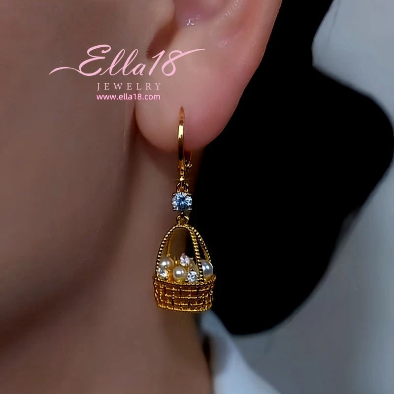 Model showcasing the dangle and style of the 14K Gold-Plated Luxury Design Zircon Diamond Pearl Basket Earrings