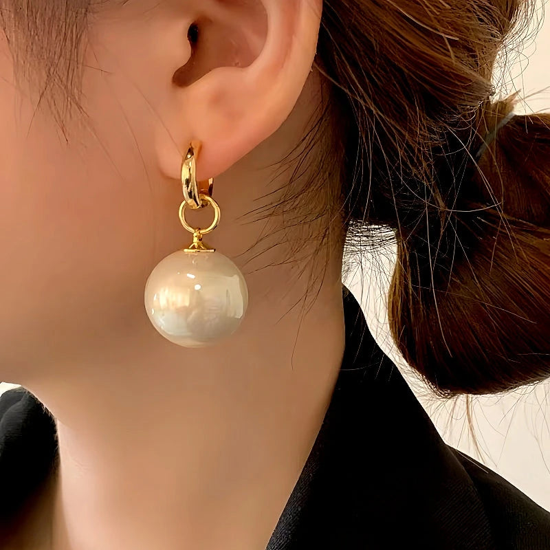 Model showcasing the dangle and style of the 14K Gold-Plated Luxury Detachable Two-Piece Pearl Earrings