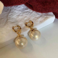 Angled view of the 14K Gold-Plated Luxury Detachable Two-Piece Pearl Earrings
