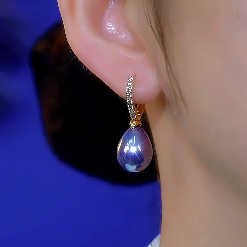 Model showcasing the dangle and style of the 14K Gold-Plated Luxury Diamond-Encrusted Purple Pearl Earrings