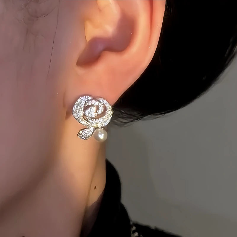 Model showcasing the dangle and style of the 14K Gold-Plated Luxury Diamond-Encrusted Zircon Rose Earrings