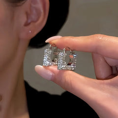Close-up detail of the sparkling zircons and plating on the Bag-Shaped Earrings