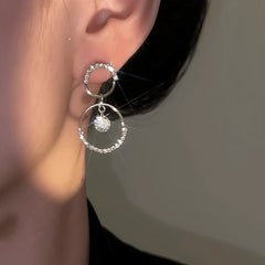 Model showcasing the dangle and style of the 14K Gold-Plated Luxury Diamond Hoop Earrings