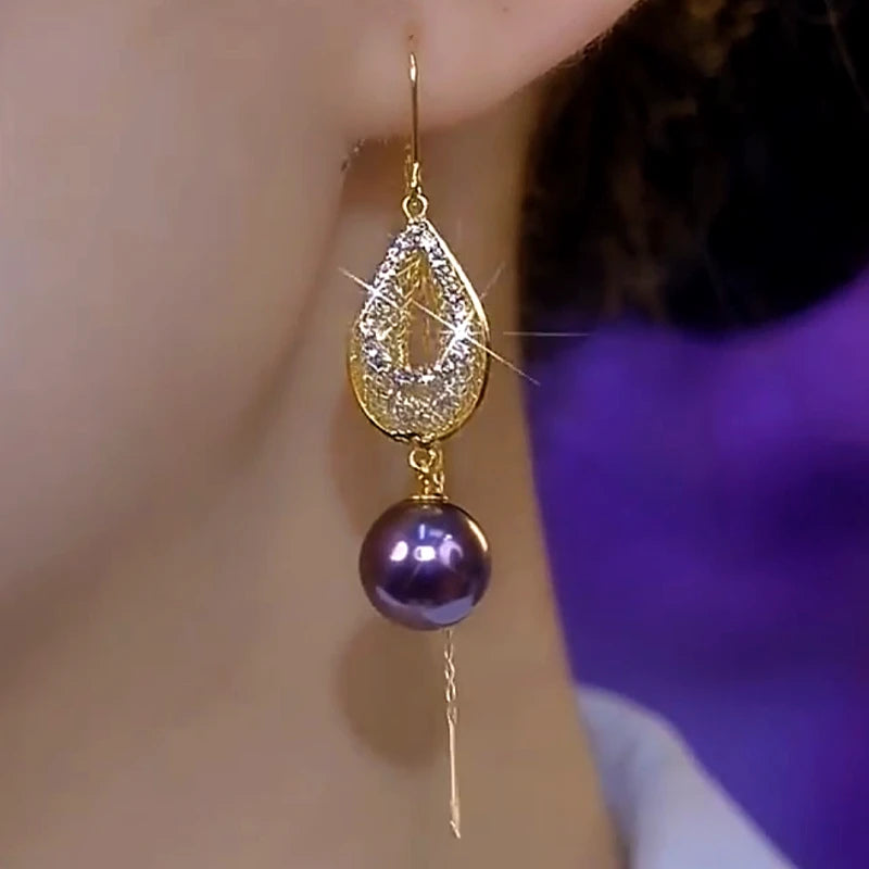 Model showcasing the dangle and style of the 14K Gold-Plated Luxury Diamond Purple Pearl Threader Earrings