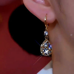 Model showcasing the dangle and style of the 14K Gold-Plated Luxury Diamond Water Drop Earrings