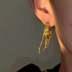 Model showcasing the dangle and style of the 14K Gold-Plated Luxury Double-Layer Chain Tassel Earrings