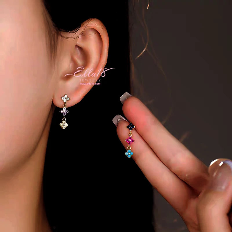 Model showcasing the dangle and style of the 14K Gold-Plated Luxury Four-Leaf Clover Tassel Earrings